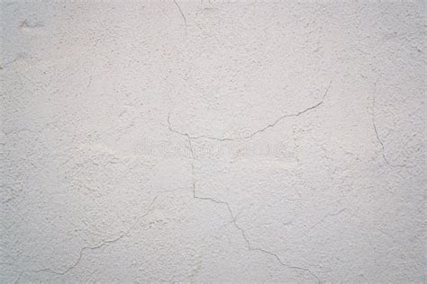 Old White Painted Concrete Wall Texture With Cracks And Weathering