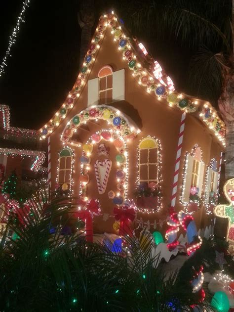 A House Covered In Christmas Lights And Decorations