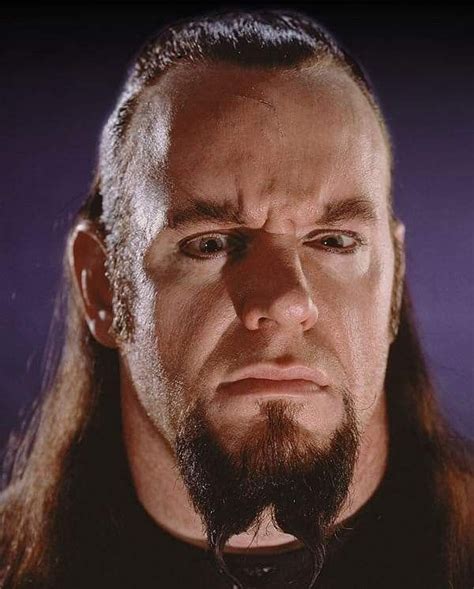 A Close Up Of A Man With Long Hair And Beard Wearing A Black Shirt