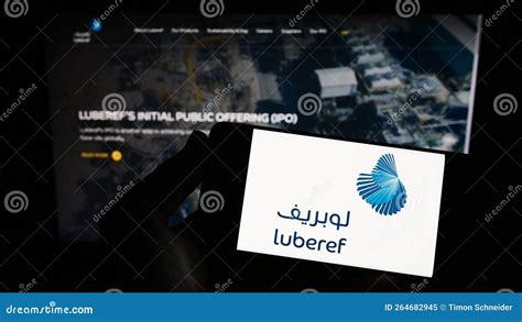 Person Holding Smartphone with Logo of Saudi Arabian Base Oil Company ...