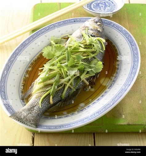 Steamed Sea Bass With Scallions And Ginger In Light Soy Sauce Red Wine And Sesame Oil Served