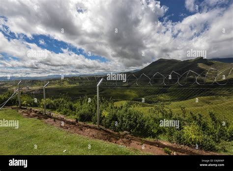 Monantsapas fenced border crossing between South Africa and Lesotho with the mountains of ...