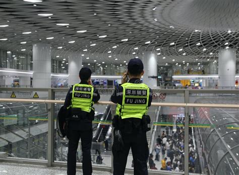 A Photo Of Two Chinese Police Officers Wearing Yellow And Green
