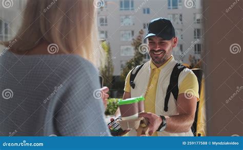 Woman Open Door To A Delivery Man On A Bike Wearing Yellow Thermal