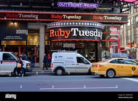 The Ruby Tuesday Restaurant On A Busy City Street With Passing Taxis
