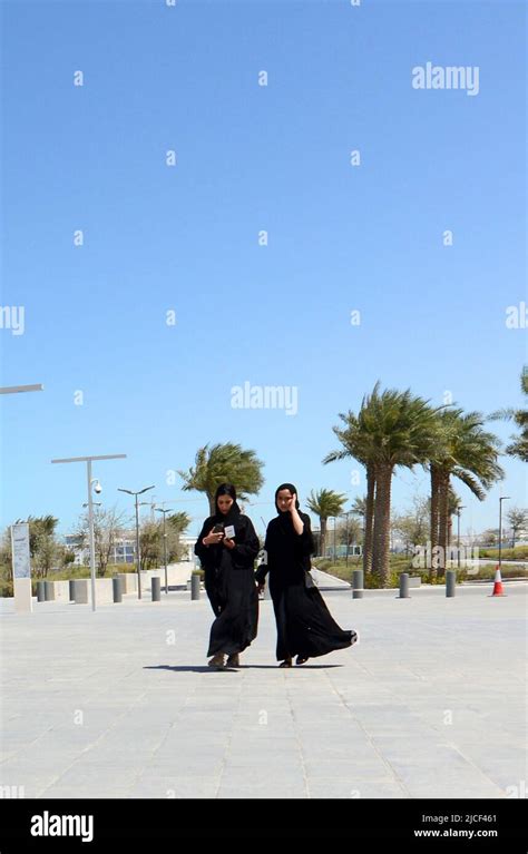 Emirati Women Walking On The Corniche Waterfront Promenade In Abu Dhabi