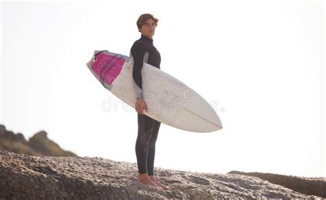 Surfing Man With Surfboard For Sports Outdoor Beach Rocks And Travel