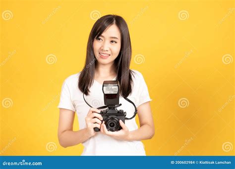 Happy Smiling Asian Young Girl Photographer And Looking Viewfinder On