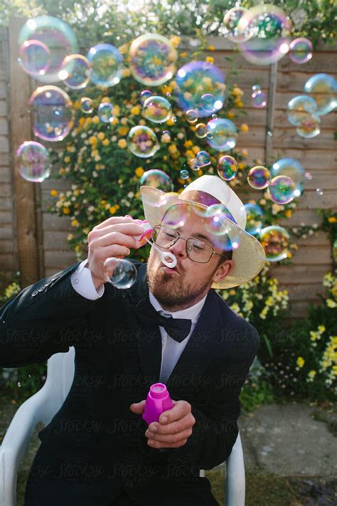 Happy Portrait Of A Man With Down S Syndrome Blowing Bubbles By