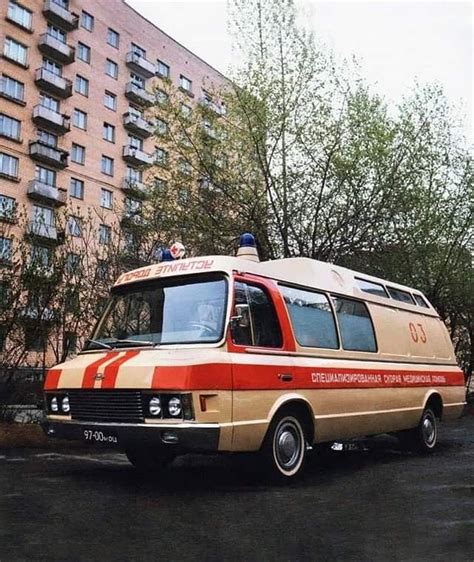 An Orange And Brown Van Parked In Front Of A Tall Building