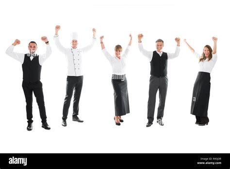 Happy Restaurant Staff Standing With Arms Raised Stock Photo Alamy