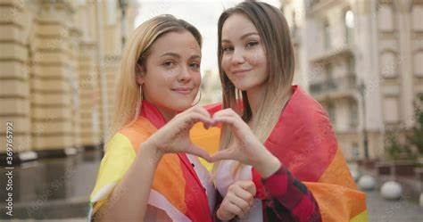 Happy Loving Homosexual Lesbian Lgbt Couple Wrapped With Rainbow Flag