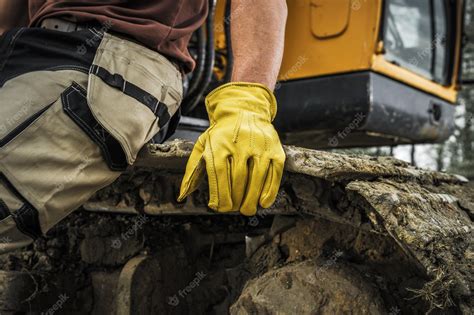 Premium Photo | Bulldozer operator resting on a caterpillar track