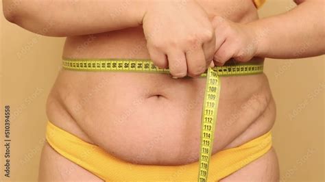 Close Up Of Unrecognizable Fat Woman Standing In Yellow Bikini Showing