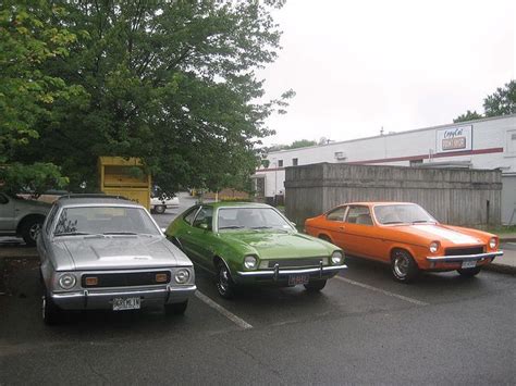 Three Cars Parked In A Parking Lot Next To Each Other