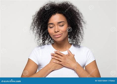 Grateful Hopeful African American Woman Holding Hands On Chest Stock