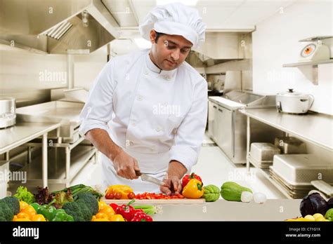 Chef Cutting Vegetables In The Kitchen Stock Photo Alamy