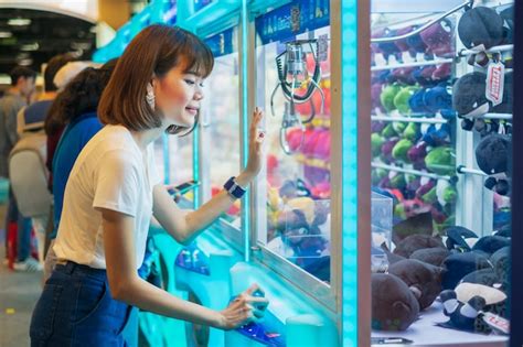 Premium Photo Happiness Woman Playing Claw Game Or Cabinet To Catch