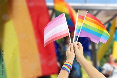 Gay pride parade view of rainbow lgbt flags over people over city background 스톡 사진 Adobe Stock
