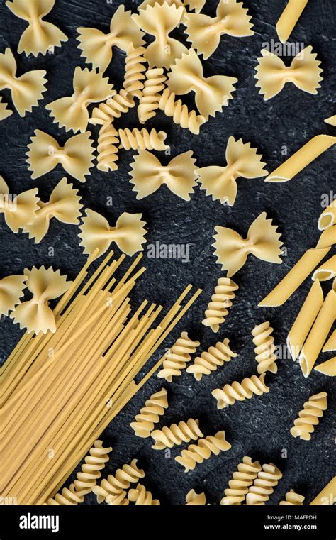 Assorted Uncooked Raw Pasta On Black Background Italian Pasta Penne