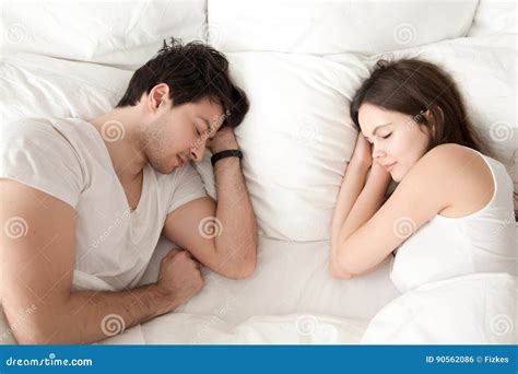 Happy Young Couple Sleeping Together In Bed Enjoying Sweet Drea Stock