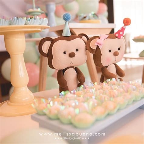 Two Teddy Bears Sitting On Top Of A Table With Cupcakes In Front Of Them