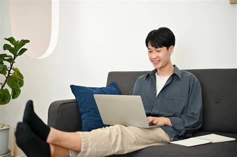 Premium Photo Relaxed And Chilling Young Asian Man Remote Working