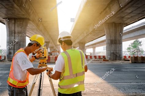 Survey Engineer Team Working With Theodolite And Road Construction