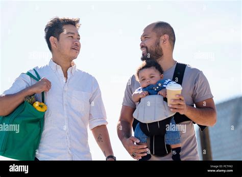 Gay Fathers Doing Errands With Baby Son Stock Photo Alamy