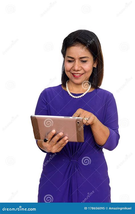 Studio Shot Of Happy Mature Asian Woman Using Digital Tablet Isolated
