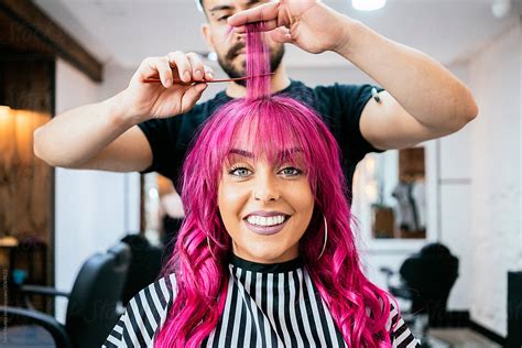 Beautiful Woman Getting Haircut By Hairdresser In The Beauty Salon By