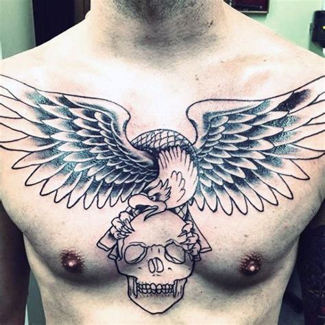 A Mans Chest With An Eagle And Skull Tattoo On The Top Of It