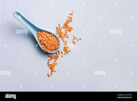 A Spoonful Of Uncooked Red Split Lentils Stock Photo Alamy