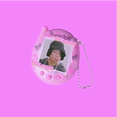 A Pink Keychain With An Image Of A Person Wearing A Hat On It