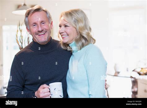 Portrait Smiling Mature Couple Drinking Tea Stock Photo Alamy