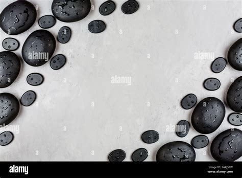 Top View Of Hot Spa Stones Set For Massage Treatment On Gray Concrete Background With Copy Space