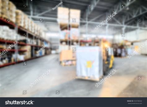 Forklift Transporting Loads Inside Industrial Warehouse Stock Photo