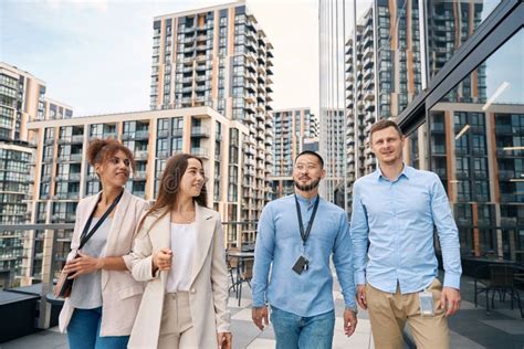 Corporate Workers Strolling Outside During Lunch Break Stock Photo