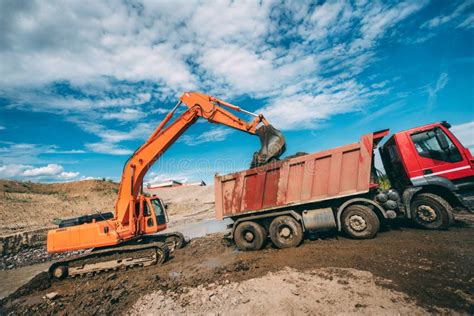 Heavy Machinery Working On Construction Site Excavator Loading Dumper