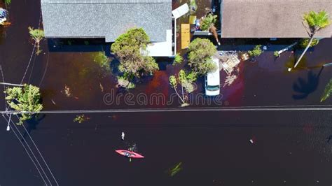 Kayak Boat Floating On Flooded Street Surrounded By Hurricane Ian