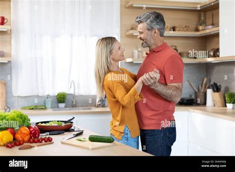 Loving Mature Spouses Dancing Together While Cooking At Kitchen Stock Photo Alamy