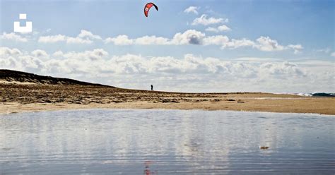 A person is flying a kite on the beach photo – Free Kite Image on Unsplash