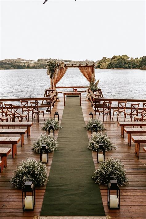 An Outdoor Wedding Ceremony Setup With Wooden Benches And Flowers On