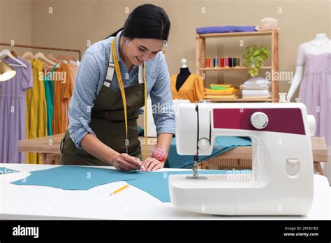 Dressmaker Marking Fabric With Chalk In Workshop Stock Photo Alamy