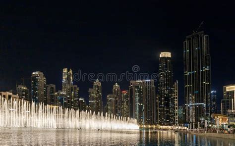 Night View Of The Famous Dubai Fountains And Illuminated Buildings On