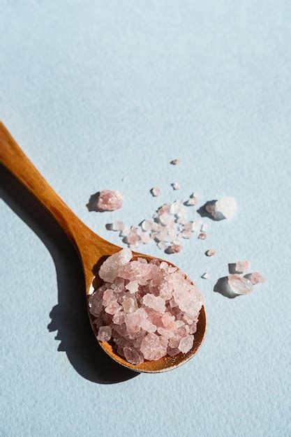 Premium Photo Himalayan Pink Salt In Wooden Spoon Placed On Blue