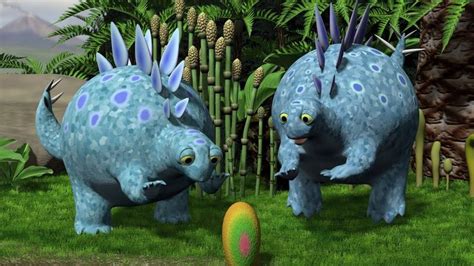 Two Blue Dinosaurs Playing With An Egg In The Grass