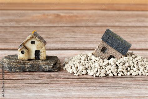 Two Miniature Houses In Sand And On Rock Stone Copy Space A Close