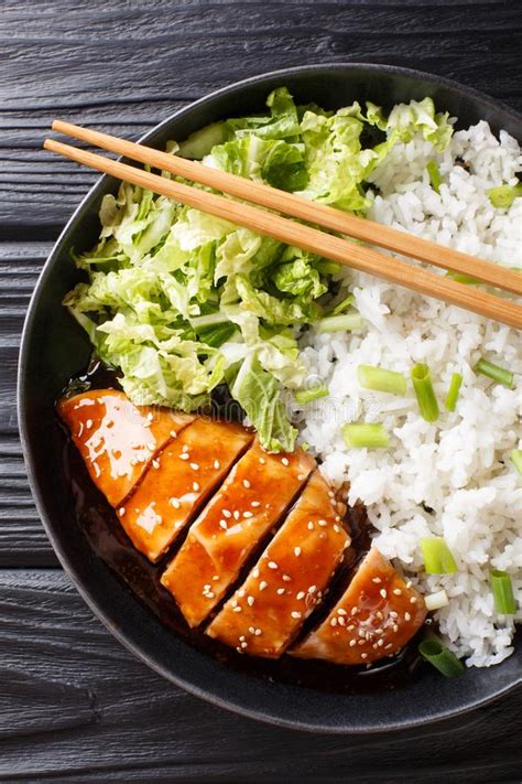 Teriyaki Chicken With Rice Garnish And Salad Close Up On A Plate