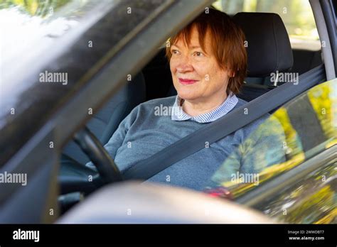 Positive Mature Woman Sitting Inside Her Car Stock Photo Alamy